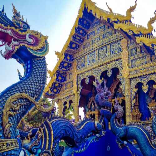 Blue Temple (Wat Rong Suea Ten) with vibrant dragon sculptures and intricate golden architecture in Thailand, highlighted in the Chiang Mai Digital Nomad Guide.
