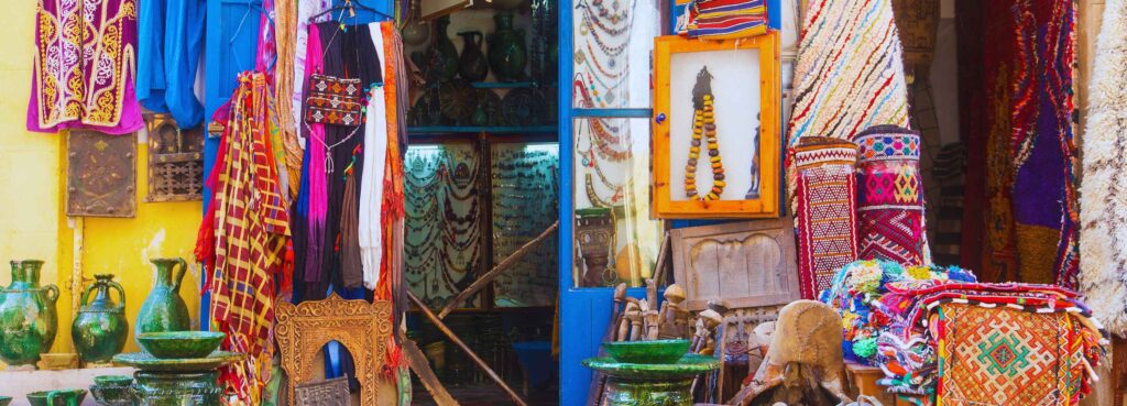 Vibrant Morocco travel guide scene: colorful markets with textiles and spices in dreamy landscapes