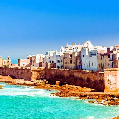 Morocco vibrant travel guide – stunning coastal view of historic Essaouira overlooking turquoise ocean.