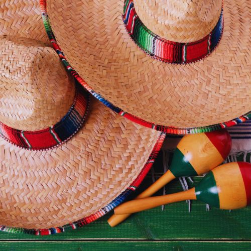 Traditional Mexican sombreros and maracas displayed on a colorful table – Remote Workers City Guide